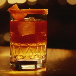 An image of the Heavy Artillery cocktail submitted by Toby that contains Rye Whiskey, Smith & Cross, Green Chartreuse, Sweet Vermouth, Cinnamon Syrup, Demerara Syrup, Whiskey Barrel Aged Bitters and Orange