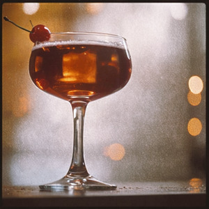 An image of the Made Man cocktail submitted by Toby that contains Rye Whiskey, Cherry Heering, Yellow Chartreuse, Fernet Branca and Cocktail Cherry
