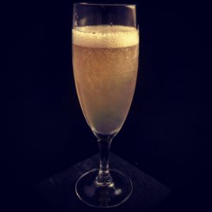 An image of the Afterword cocktail submitted by n0tquitethere that contains Mezcal, Yellow Chartreuse, Amaro Montenegro, Lime and Prosecco