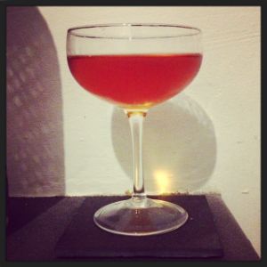 An image of the Always Crashing The Same Car cocktail submitted by n0tquitethere that contains Apple Brandy, Suze, Green Chartreuse, Angostura Bitters and Grapefruit