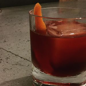 An image of the Arbitrary Nature of Time cocktail submitted by n0tquitethere that contains Bourbon, Turin Bitters, Cherry Brandy, Orange Bitters, Xocolatl Mole Bitters and Orange