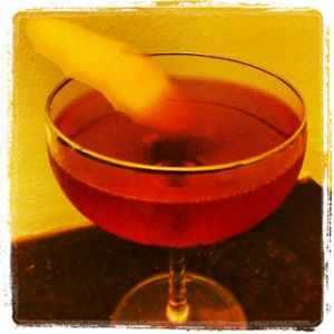 An image of the Broken English cocktail submitted by n0tquitethere that contains London Dry Gin, Sweet Vermouth, Strega, Fernet Branca, Benedictine DOM, Orange Bitters, Peychauds Bitters and Grapefruit