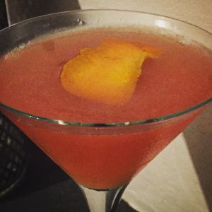 An image of the Caricature Cocktail cocktail submitted by n0tquitethere that contains London Dry Gin, Sweet Vermouth, Turin Bitters, Grapefruit, Simple Syrup and Orange