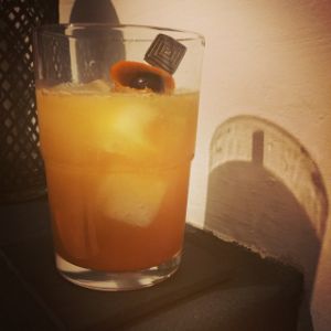 An image of the Desert Healer cocktail submitted by n0tquitethere that contains London Dry Gin, Cherry Brandy, Orange, Ginger Ale, Orange and Cocktail Cherry