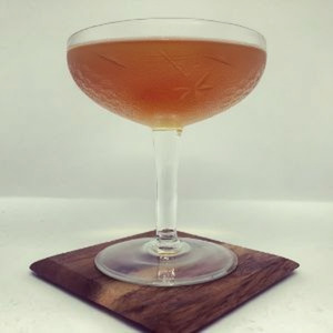 An image of the East India Cocktail cocktail submitted by Toby that contains Brandy, Raspberry Syrup, Angostura Bitters, Curaçao Triple Sec, Maraschino Liqueur and Cocktail Cherry