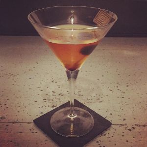 An image of the Eastern Manhatten cocktail submitted by n0tquitethere that contains Japanese Whiskey, Sweet Vermouth, Absinthe and Cocktail Cherry