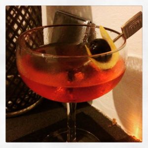 An image of the El Corazon cocktail submitted by n0tquitethere that contains Reposado Tequila, Aperol, Sweet Vermouth, Cherry Bitters, Grapefruit and Cocktail Cherry