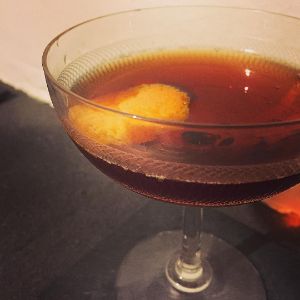 An image of the Fire-Breathing Devil cocktail submitted by n0tquitethere that contains Sloe Gin, Dry Vermouth, Sweet Vermouth, Smith & Cross, Orange Bitters and Orange