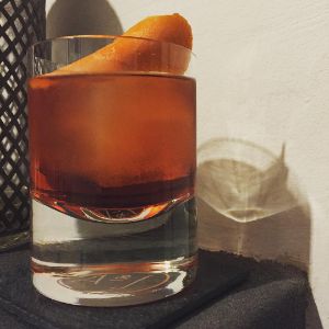 An image of the Foreign Legion cocktail submitted by n0tquitethere that contains Gold Rum, Aperol, Dubonnet Rouge, Manzanilla Sherry, Crème de Cacao Blanc, Rhubarb Bitters and Orange