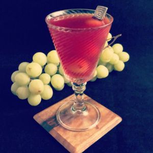 An image of the Green Harvest cocktail submitted by n0tquitethere that contains Hibiscus Tea, Blanco Tequila, Green Chartreuse and White Grapes