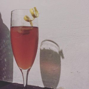 An image of the Handbook For The Recently Deceased cocktail submitted by n0tquitethere that contains Bourbon, Falernum, Peychauds Bitters, Angostura Bitters, Prosecco and Lemon