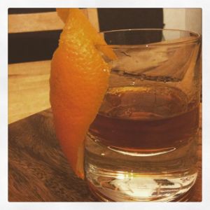 An image of the The Hotel Room Temperature cocktail submitted by n0tquitethere that contains Sweet Vermouth, Gold Rum, Curaçao Triple Sec, Xocolatl Mole Bitters and Orange