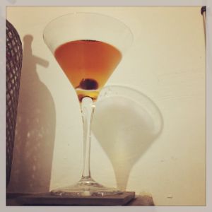 An image of the Luna de Cosecha cocktail submitted by n0tquitethere that contains Anejo Tequila, Sweet Vermouth, Cynar, Crème de Cacao Blanc and Cocktail Cherry