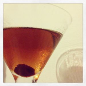 An image of the Nick's Own cocktail submitted by n0tquitethere that contains Brandy, Sweet Vermouth, Angostura Bitters, Absinthe, Lemon and Cocktail Cherry