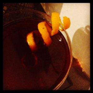 An image of the Not The First Cyn cocktail submitted by n0tquitethere that contains Bourbon, Cynar, Cherry Brandy, Rhubarb Bitters and Orange
