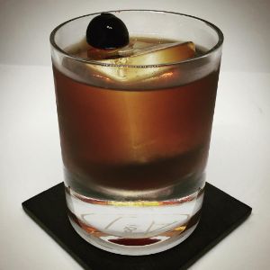An image of the Old Ironside cocktail submitted by n0tquitethere that contains Spiced Rum, Cherry Brandy, Cynar and Cocktail Cherry