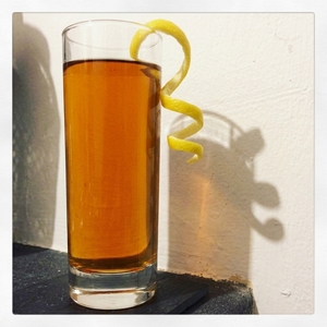 An image of the Smoky Iced Tea and Whiskey Cooler cocktail submitted by Toby that contains Tea Lapsang Souchong, Lemon, Ginger Liqueur, Rye Whiskey, Angostura Bitters and Lemon