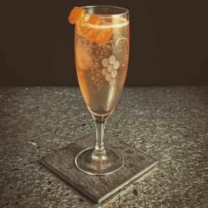 An image of the The Seelbach Cocktail cocktail submitted by n0tquitethere that contains Bourbon, Curaçao Triple Sec, Angostura Bitters, Peychauds Bitters, Champagne and Orange