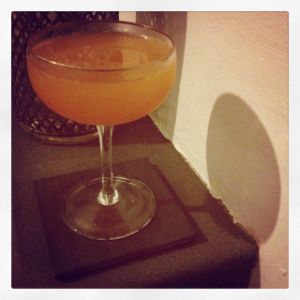 An image of the Velvet Cushion cocktail submitted by n0tquitethere that contains London Dry Gin, Apple Brandy, Swedish Flaggpunsch, Orange and Crème de Cassis